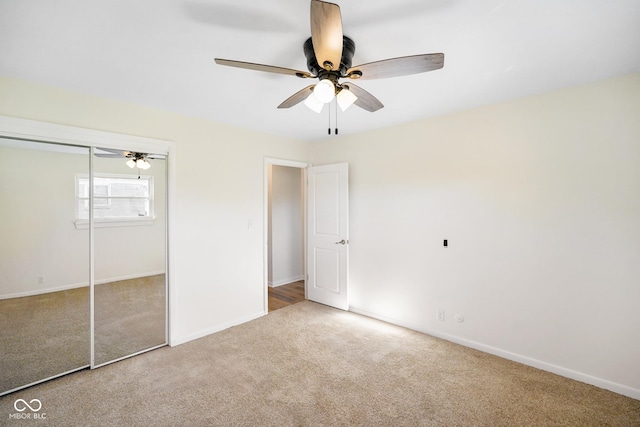 unfurnished bedroom featuring a closet, ceiling fan, baseboards, and carpet