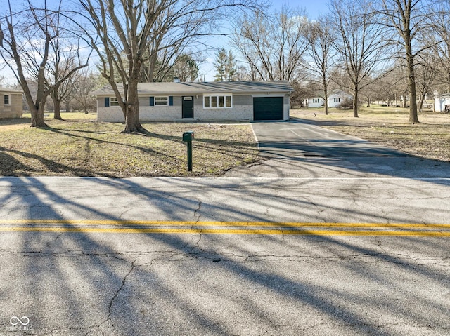 view of front of home with concrete driveway, brick siding, and a garage