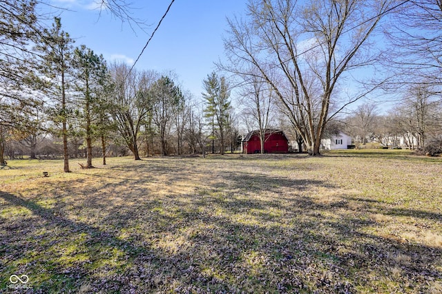 view of yard with an outdoor structure, a garage, and a barn