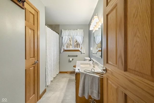 bathroom featuring vanity, toilet, baseboards, and visible vents