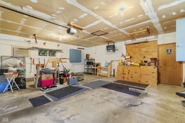 garage featuring a garage door opener and a wall mounted AC