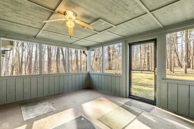 unfurnished sunroom with a ceiling fan