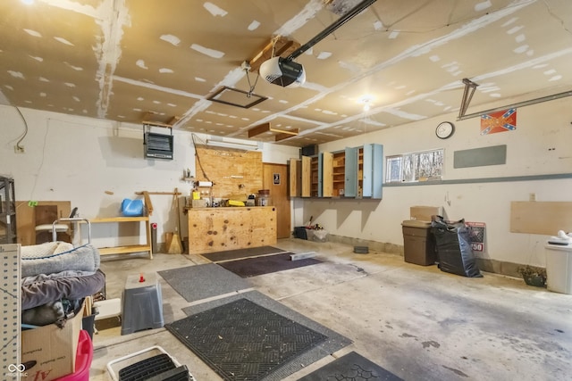 garage featuring heating unit and a garage door opener