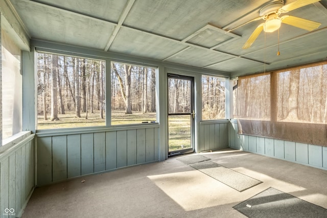 unfurnished sunroom with ceiling fan