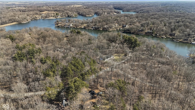 aerial view with a forest view and a water view