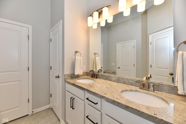 bathroom with a sink, double vanity, and tile patterned flooring