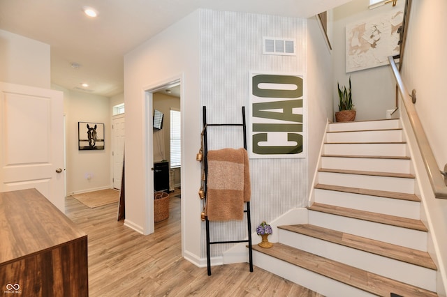 stairs featuring recessed lighting, visible vents, baseboards, and wood finished floors