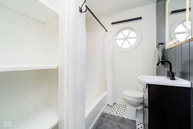 bathroom with tile patterned floors, plenty of natural light, toilet, and vanity