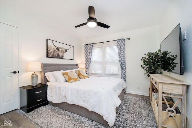 bedroom featuring a ceiling fan, wood finished floors, and baseboards