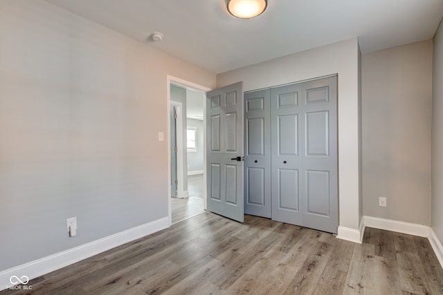 301 Villa Ave, Indianapolis, IN 46201 - unfurnished bedroom with wood finished floors, baseboards, and a closet
