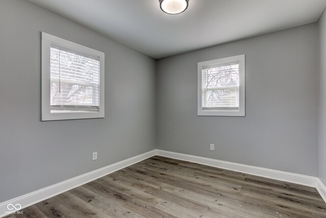 301 Villa Ave, Indianapolis, IN 46201 - unfurnished room featuring a healthy amount of sunlight, baseboards, and wood finished floors