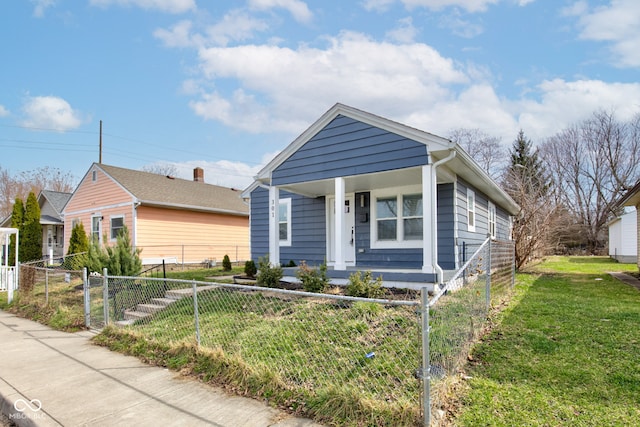 301 Villa Ave, Indianapolis, IN 46201 - bungalow-style home featuring a fenced front yard, a porch, and a front lawn