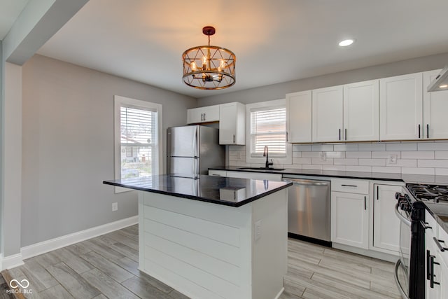 301 Villa Ave, Indianapolis, IN 46201 - kitchen featuring gas stove, freestanding refrigerator, a sink, dishwasher, and backsplash