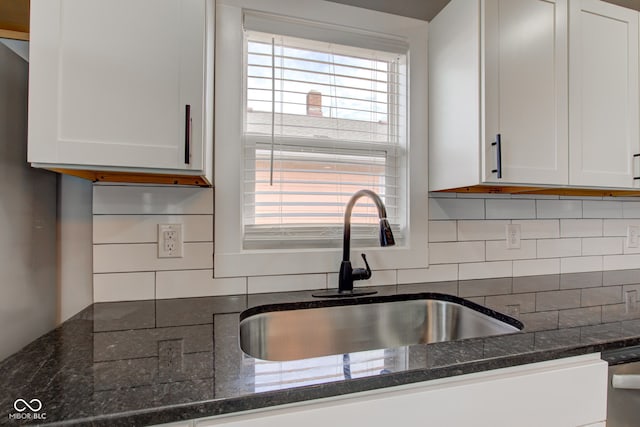 301 Villa Ave, Indianapolis, IN 46201 - kitchen with decorative backsplash, white cabinets, dark stone counters, and a sink