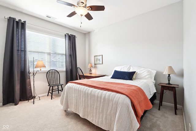 carpeted bedroom featuring visible vents, a ceiling fan, and baseboards