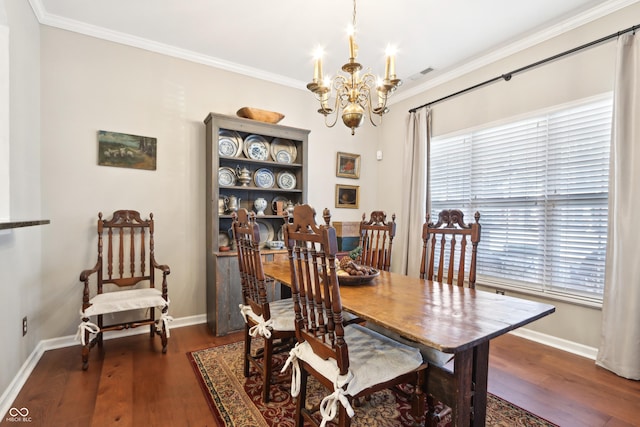 dining room with a chandelier, a healthy amount of sunlight, wood finished floors, and ornamental molding