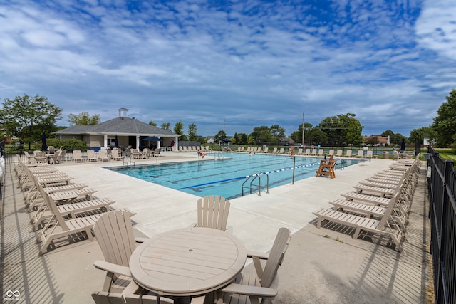 community pool featuring a patio and fence