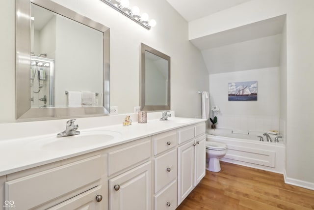 bathroom featuring a sink, wood finished floors, a bath, and double vanity