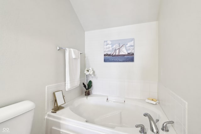 full bathroom with toilet and a garden tub