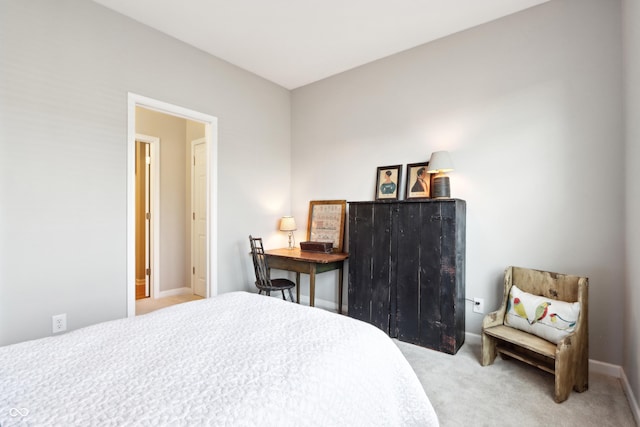 bedroom featuring baseboards and carpet