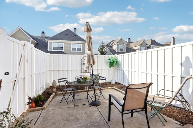 view of patio with a fenced backyard and outdoor dining space