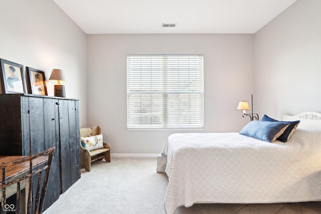 carpeted bedroom with visible vents and baseboards