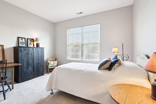 carpeted bedroom featuring visible vents