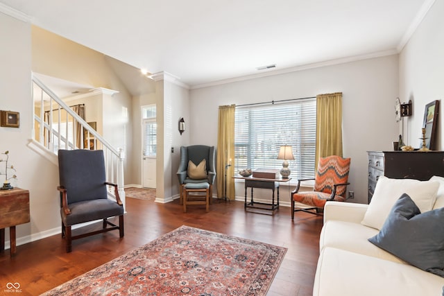 living room with visible vents, ornamental molding, stairs, and wood finished floors