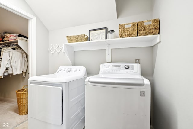 clothes washing area featuring laundry area and washer and clothes dryer