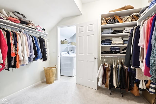 walk in closet with lofted ceiling and carpet