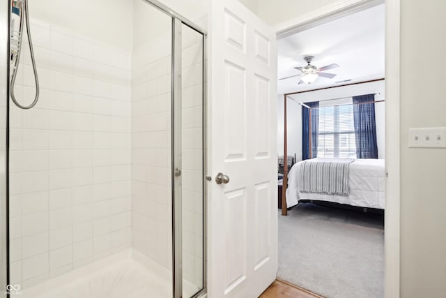 ensuite bathroom featuring ensuite bath, a stall shower, and ceiling fan