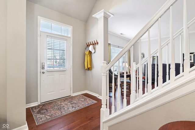 foyer featuring stairs, vaulted ceiling, wood finished floors, and baseboards