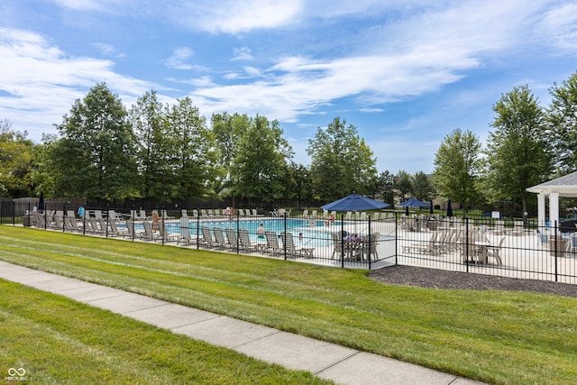 pool featuring a yard and fence