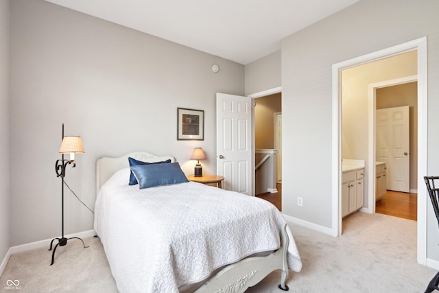 bedroom featuring light colored carpet and baseboards