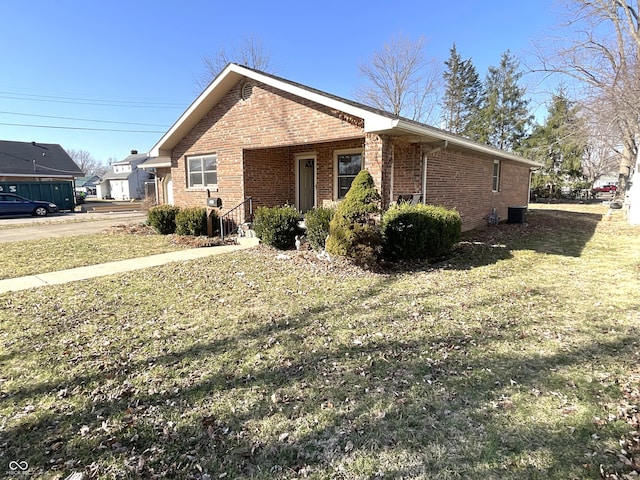 view of property exterior with a yard and brick siding