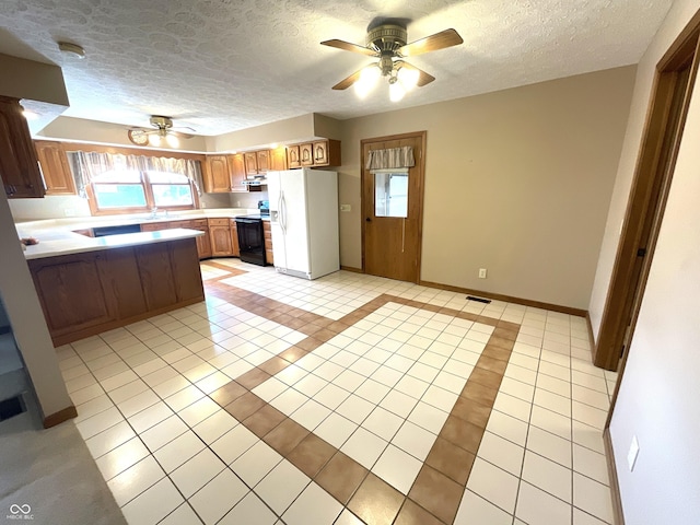 kitchen featuring light countertops, light tile patterned floors, white refrigerator with ice dispenser, electric range, and a ceiling fan