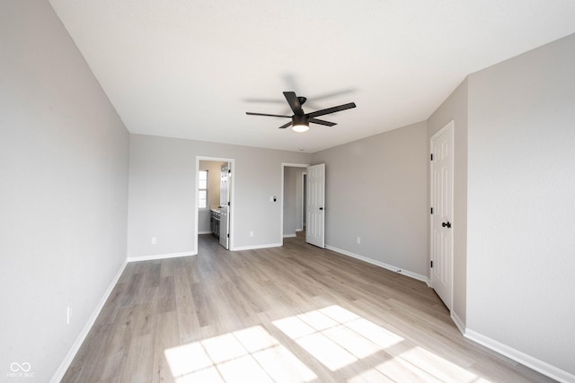 unfurnished bedroom featuring a ceiling fan, light wood-style floors, and baseboards