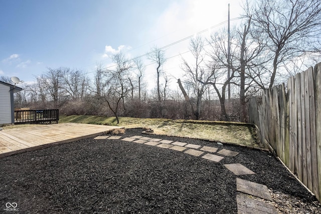 view of yard featuring a fenced backyard and a deck