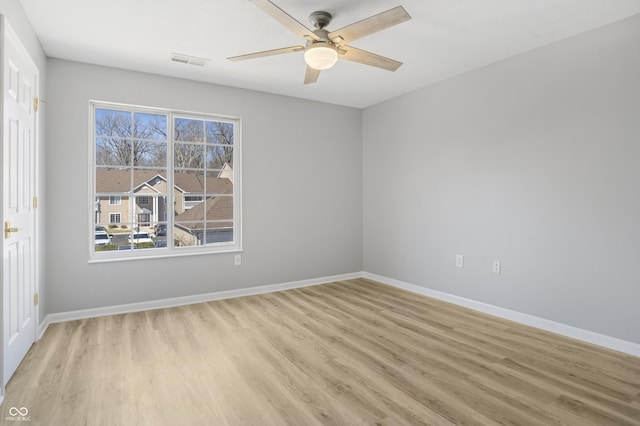 empty room with ceiling fan, visible vents, baseboards, and light wood-style flooring