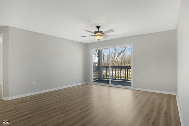 spare room with ceiling fan, baseboards, and wood finished floors