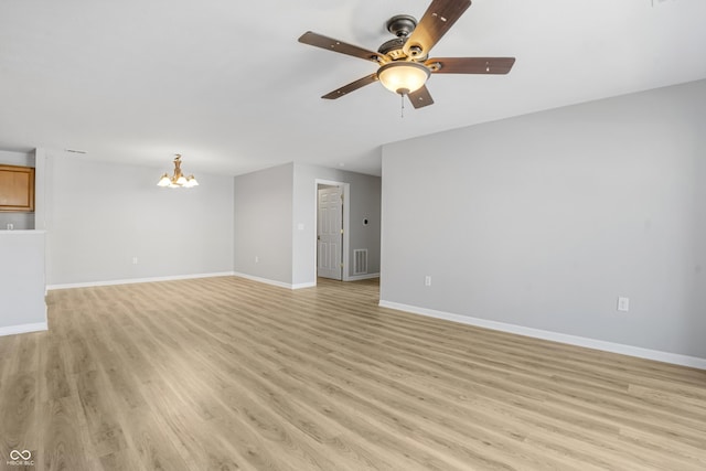 unfurnished living room featuring visible vents, ceiling fan with notable chandelier, light wood-type flooring, and baseboards