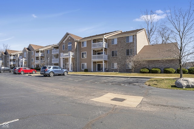 view of building exterior with uncovered parking