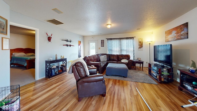 7853 Wildwood Farms Ln, Indianapolis, IN 46239 - living room with light wood-type flooring and a textured ceiling