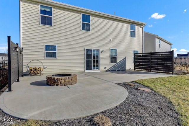 back of property featuring a patio area, an outdoor fire pit, and fence