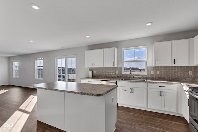 kitchen featuring backsplash, dark wood-type flooring, recessed lighting, and a center island