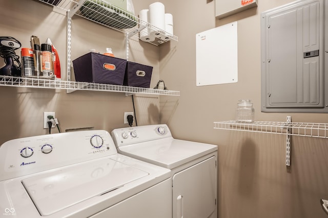 clothes washing area featuring electric panel, laundry area, and washer and clothes dryer