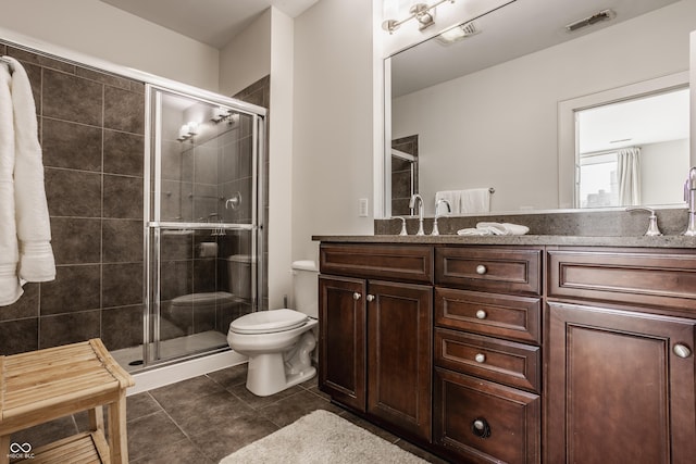 full bathroom featuring visible vents, toilet, a shower stall, tile patterned flooring, and vanity