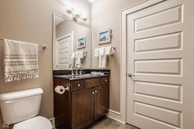 bathroom featuring vanity, toilet, and tile patterned flooring