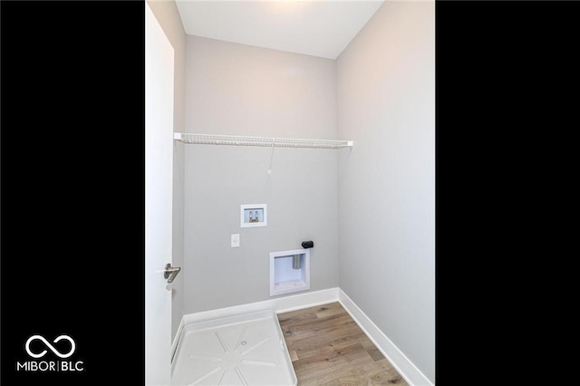 laundry area with baseboards, light wood-style floors, hookup for a washing machine, and laundry area