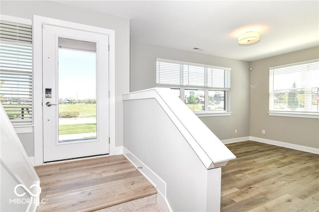 interior space with visible vents, wood finished floors, and baseboards